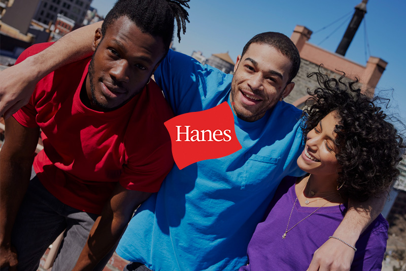 Two women wearing Hanes product and the Hanes logo